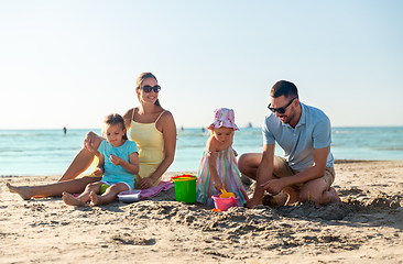 Image showing happy family with daughters on summer beach