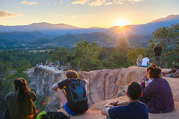 Image showing People watching sunset over mountains 