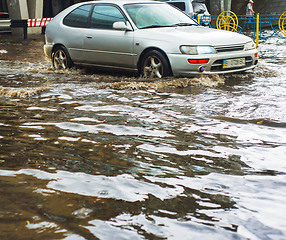 Image showing Car driving flood city road