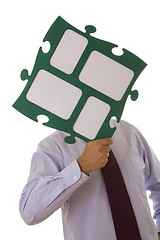 Image showing businessman holding puzzle piece