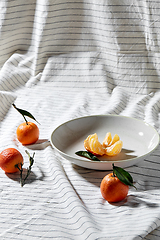 Image showing still life with mandarins on plate over drapery