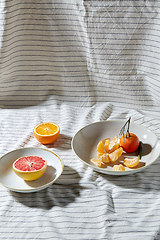 Image showing still life with mandarins and grapefruit on plate