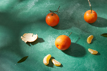 Image showing still life with mandarins on green background