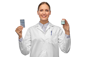 Image showing smiling female doctor holding medicine pills