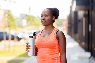 Image showing african american woman drinking water from bottle