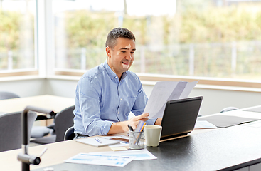 Image showing middle-aged man with vitiligo working at home