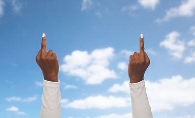 Image showing hands of african woman showing middle fingers