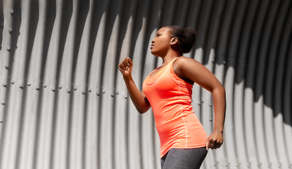 Image showing young african american woman running in tunnel