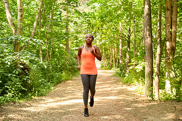 Image showing young african american woman running in forest