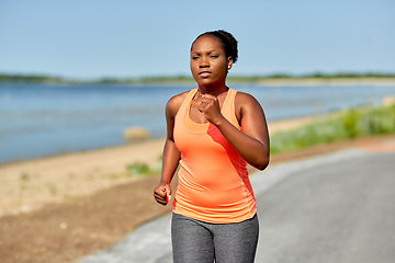 Image showing young african american woman running at seaside