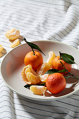 Image showing still life with mandarins on plate over drapery