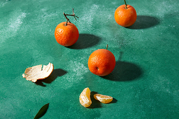 Image showing still life with mandarins on green background