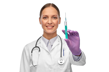 Image showing smiling female doctor with medicine in syringe