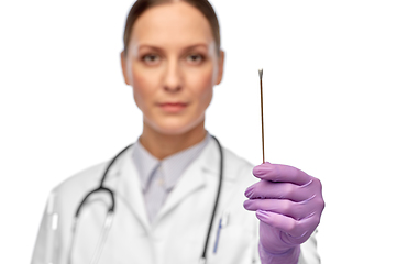 Image showing close up of female doctor with cotton swab