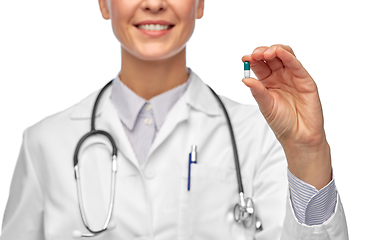 Image showing smiling female doctor holding medicine pill