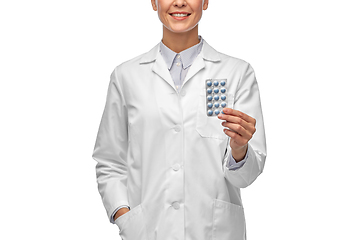 Image showing smiling female doctor holding medicine pills