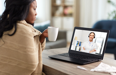 Image showing sick woman having video call with doctor on laptop