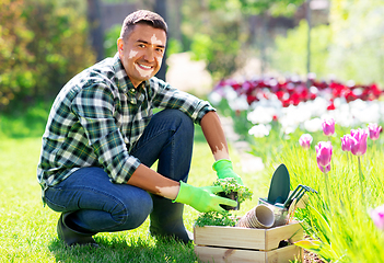 Image showing middle-aged man with vitiligo working at garden