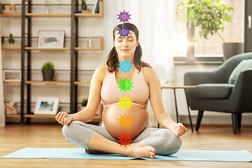 Image showing pregnant woman meditating at home