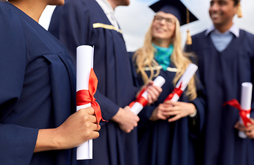 Image showing graduate students in mortar boards with diplomas