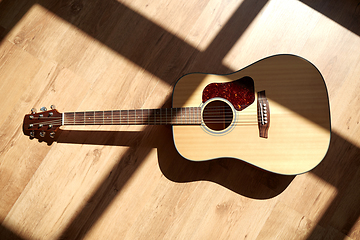 Image showing close up of acoustic guitar on wooden floor