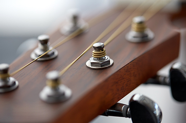 Image showing close up of acoustic guitar head with pegs