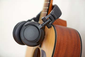 Image showing close up of acoustic guitar and headphones