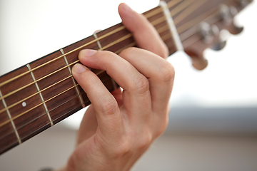 Image showing close up of hand with guitar neck playing music