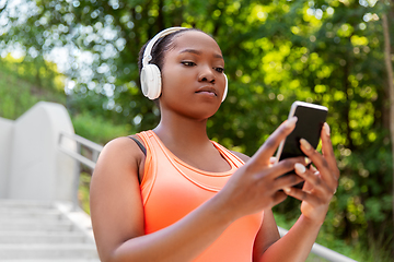 Image showing african american woman with headphones and phone