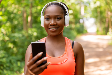 Image showing african american woman with headphones and phone