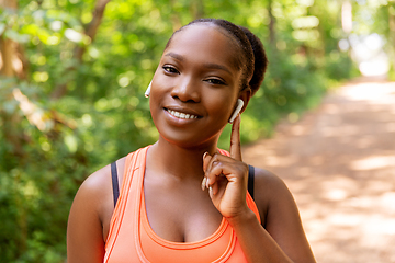 Image showing happy african american woman with earphones