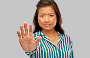 Image showing close up of asian woman showing stop gesture