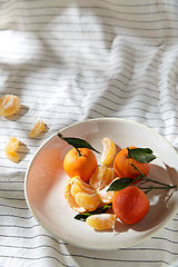 Image showing still life with mandarins on plate over drapery