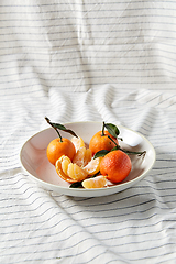 Image showing still life with mandarins on plate over drapery