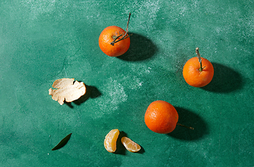 Image showing still life with mandarins on green background