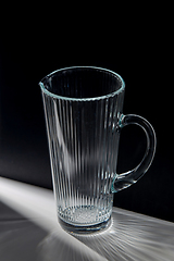 Image showing empty faceted glass jug on table