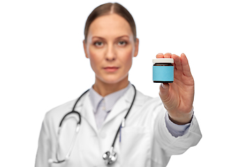 Image showing female doctor holding jar of medicine