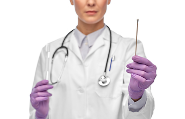 Image showing female doctor with cotton swab and test tube