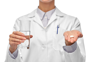 Image showing female doctor with medicine and glass of water