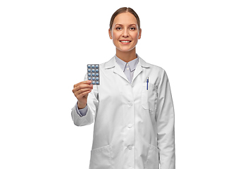 Image showing smiling female doctor holding medicine pills