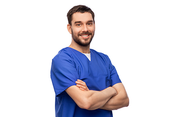 Image showing happy smiling doctor or male nurse in blue uniform