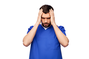 Image showing stressed doctor or male nurse in blue uniform