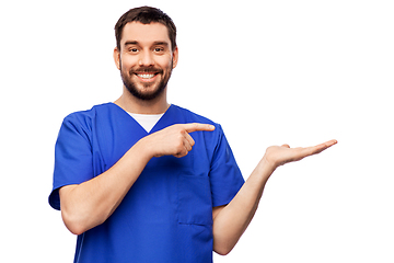 Image showing smiling male doctor holding something on hand