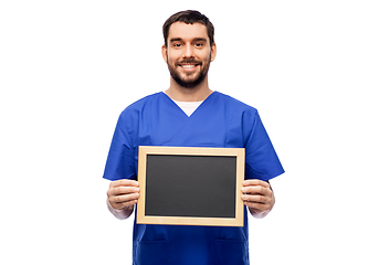 Image showing happy smiling male doctor or nurse with chalkboard