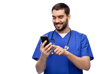 Image showing smiling doctor or male nurse using smartphone