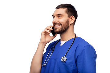 Image showing smiling doctor or male nurse calling on smartphone