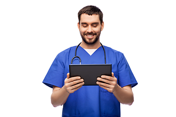 Image showing smiling doctor or male nurse using tablet computer