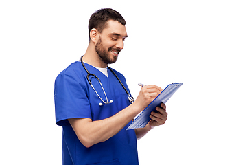 Image showing male doctor writing medical report on clipboard