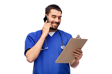 Image showing smiling doctor or male nurse calling on smartphone