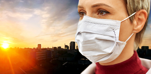 Image showing young woman wearing protective medical mask